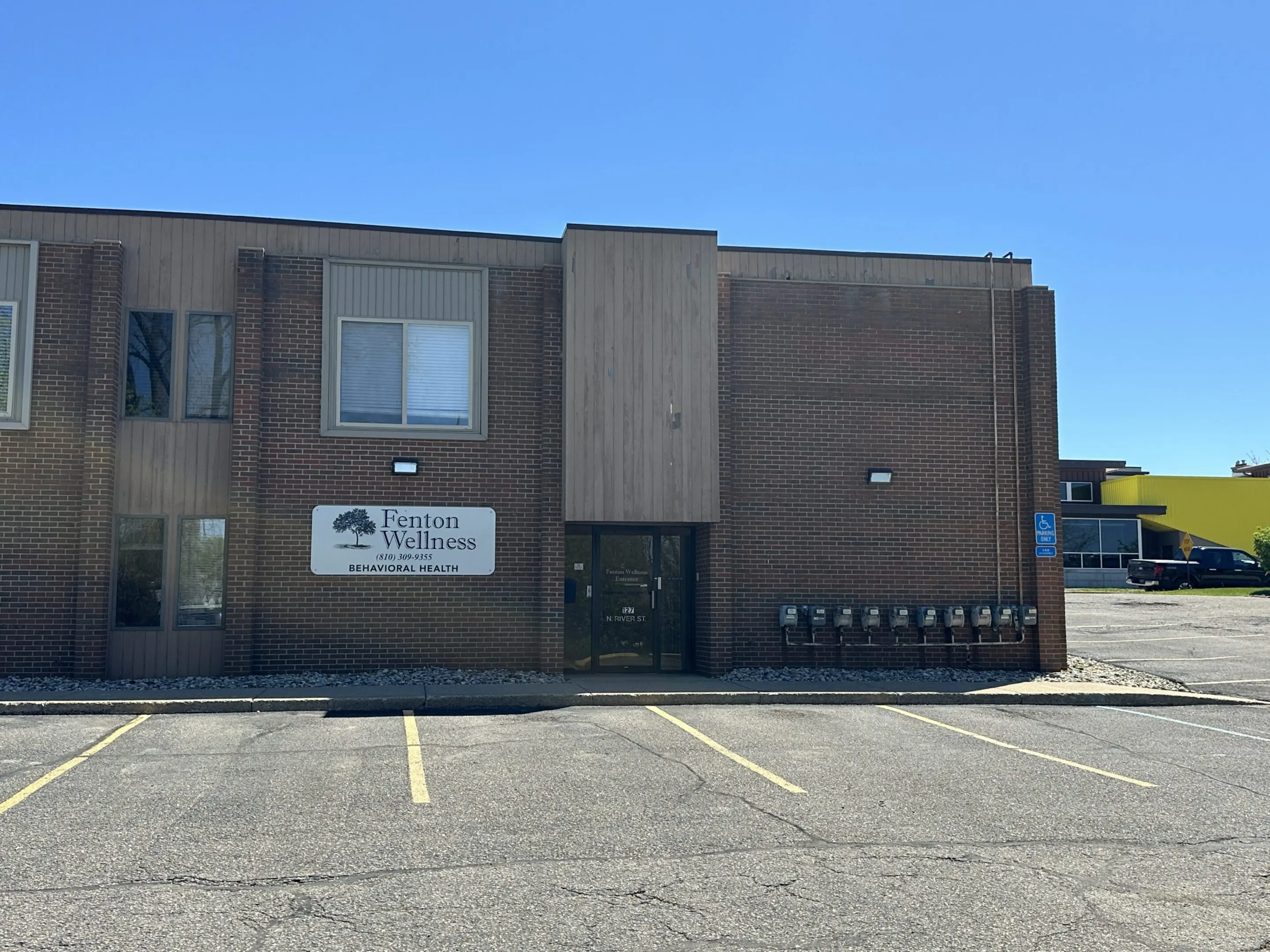 Two-story building under clear blue sky