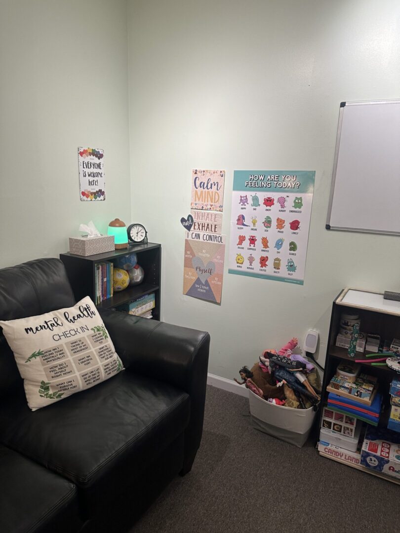 Therapy room corner with couch and emotion posters
