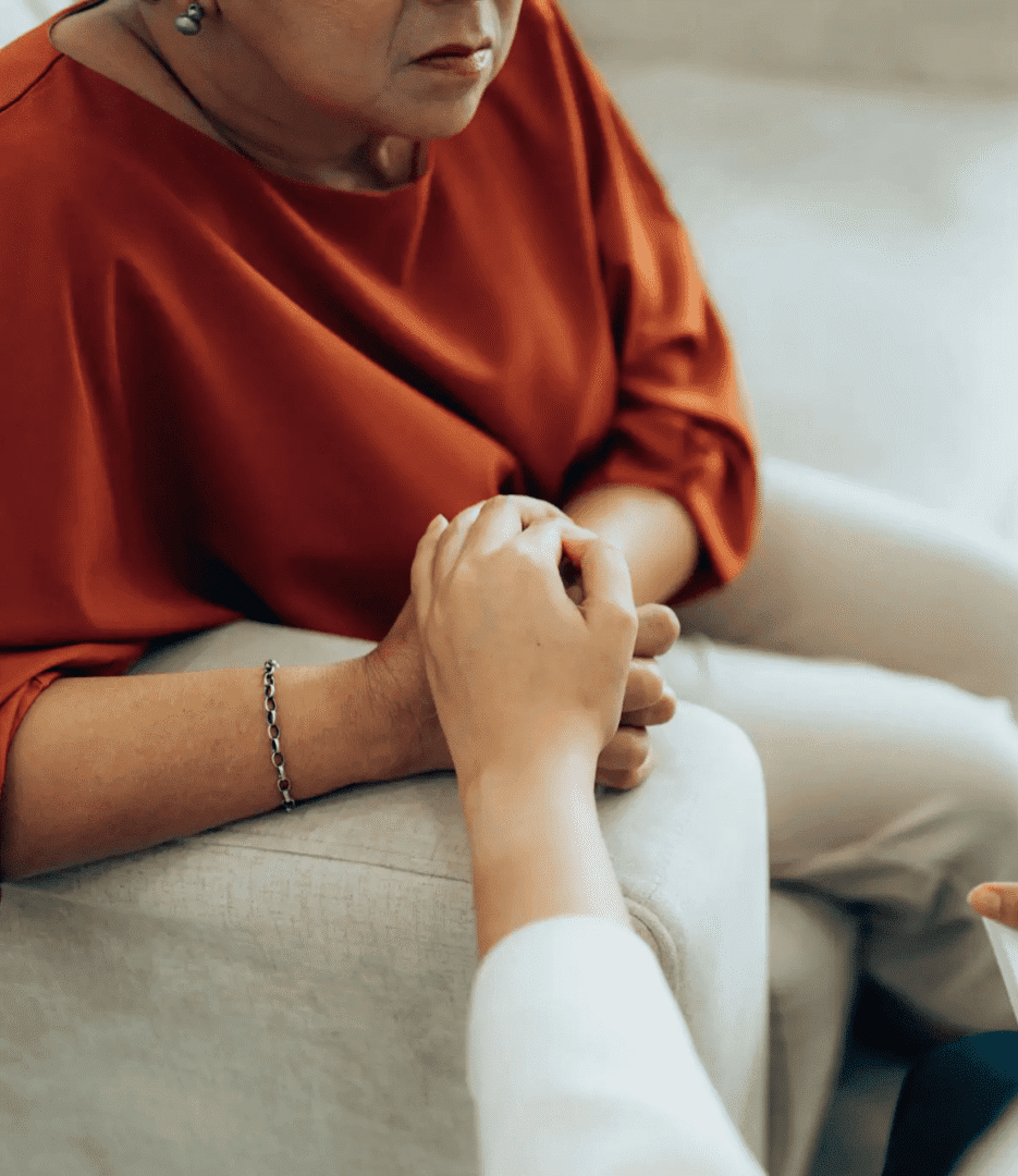 Close-up of hands holding in comforting gesture