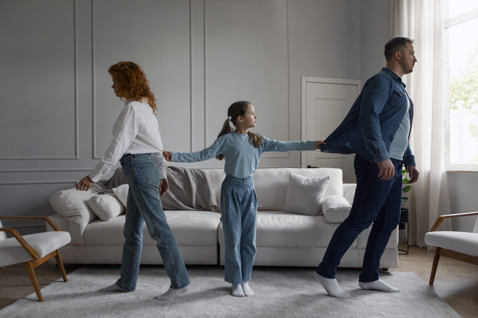 Child pulling parents in opposite directions