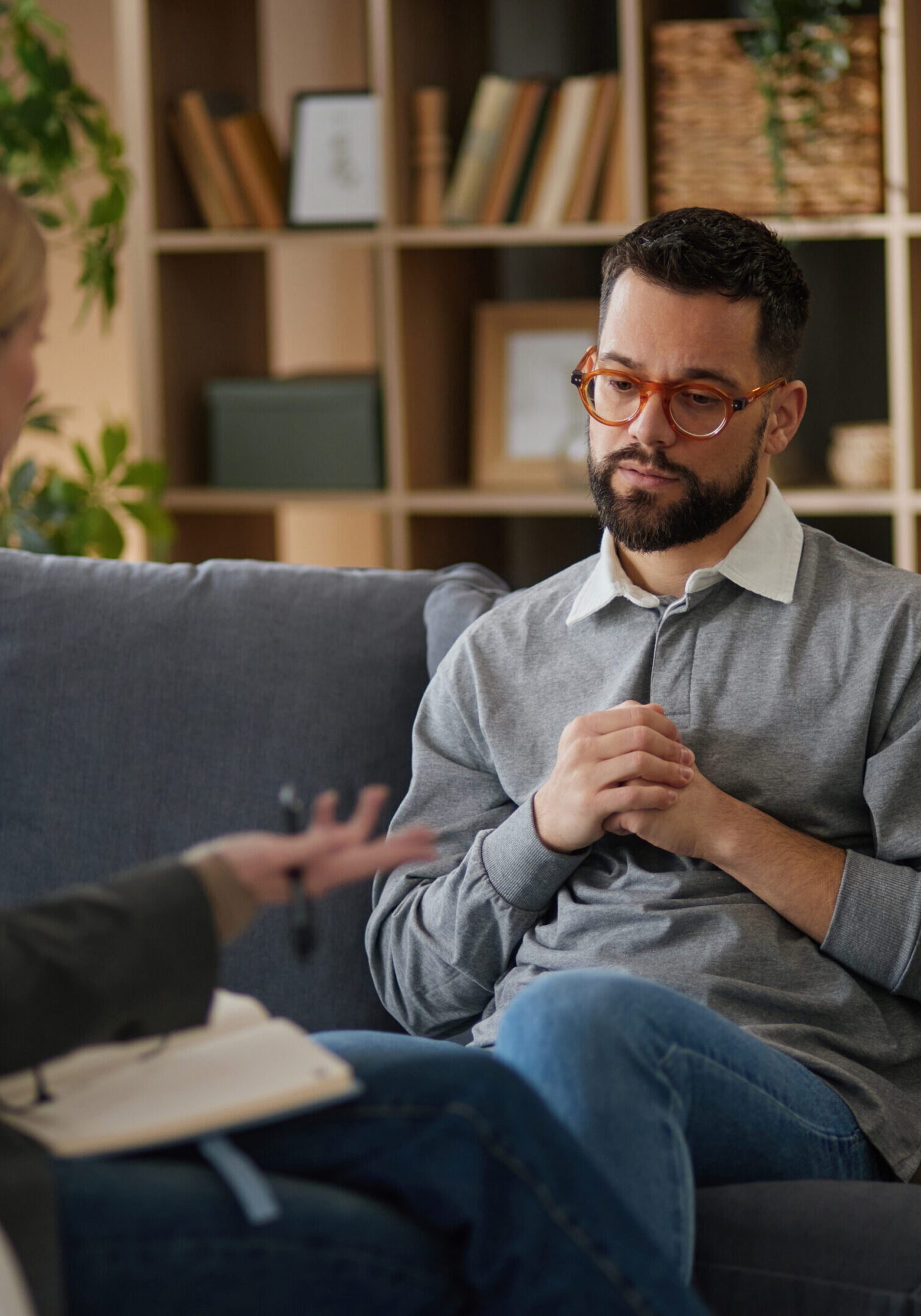 Young man having therapy session with counselor, focusing on his mental wellbeing